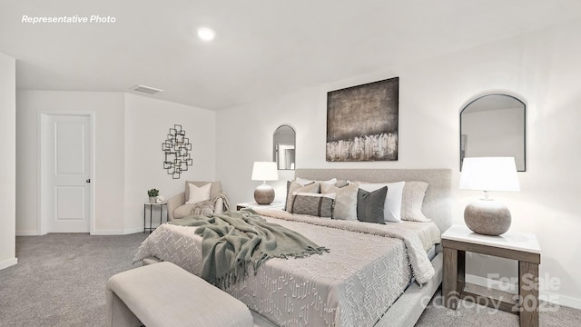carpeted bedroom featuring baseboards, visible vents, and arched walkways