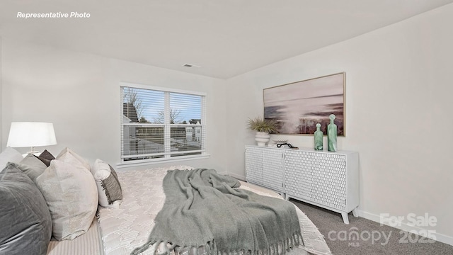 bedroom with baseboards, visible vents, and carpet