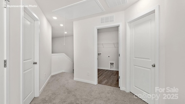 hall with visible vents, baseboards, attic access, recessed lighting, and carpet