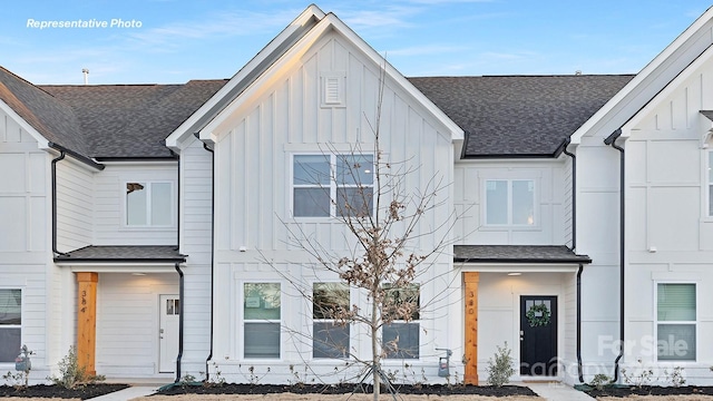 modern farmhouse style home featuring board and batten siding and roof with shingles