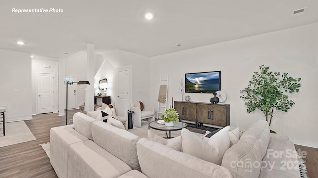 living area featuring wood finished floors, visible vents, recessed lighting, and baseboards