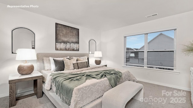 carpeted bedroom featuring visible vents and baseboards