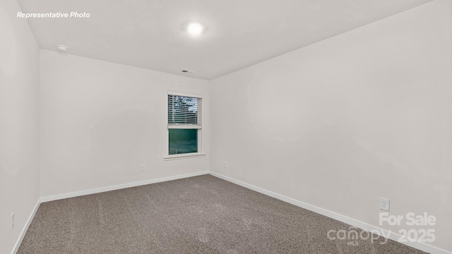 empty room featuring visible vents, carpet flooring, and baseboards
