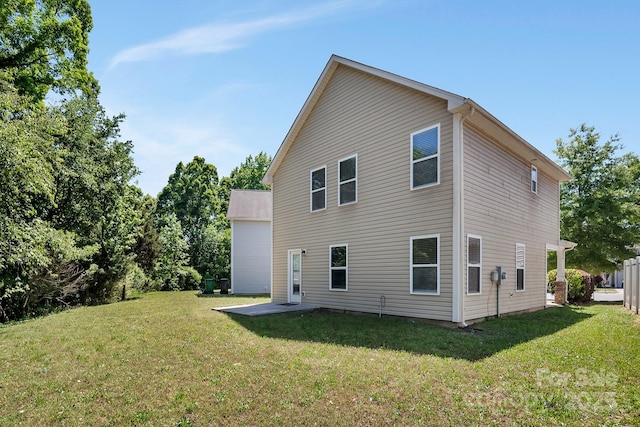 rear view of house with a lawn and a patio area