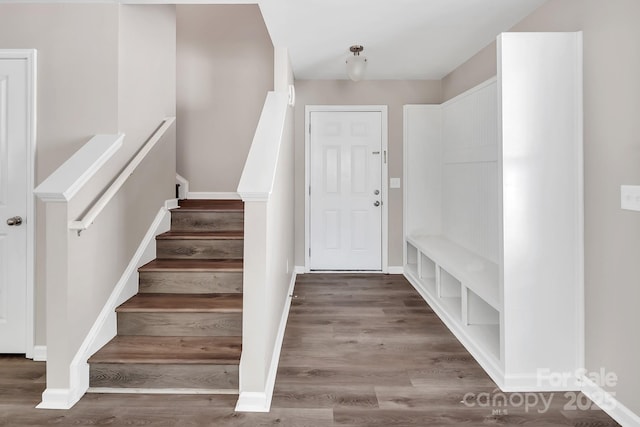 interior space featuring baseboards and wood finished floors