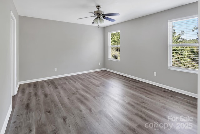 unfurnished room with baseboards, a ceiling fan, and wood finished floors
