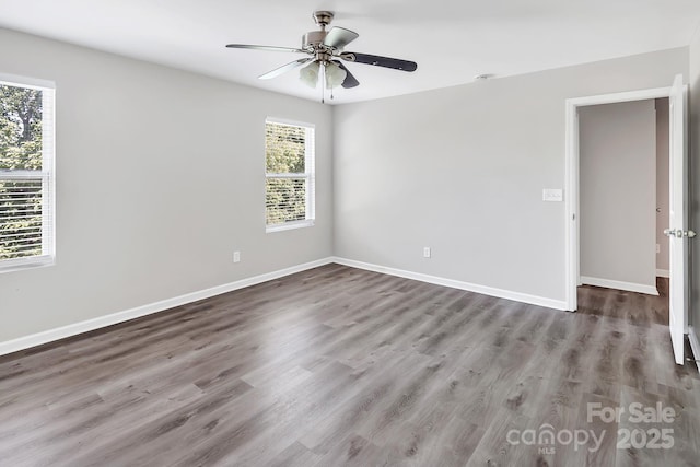 spare room with baseboards, a ceiling fan, and wood finished floors