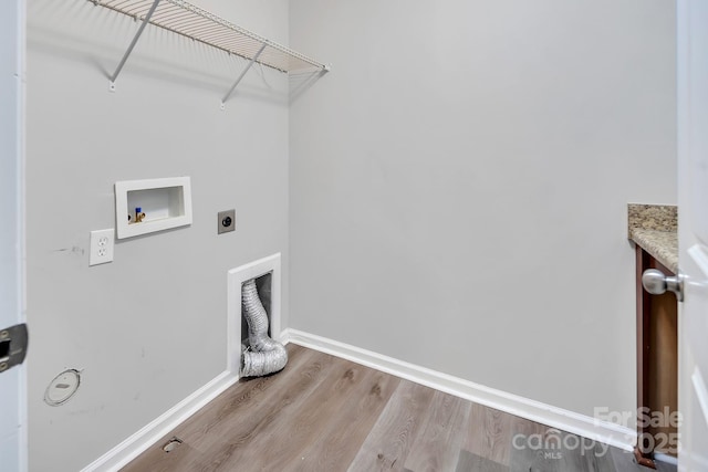 washroom with washer hookup, hookup for an electric dryer, laundry area, wood finished floors, and baseboards