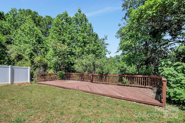 view of yard featuring fence and a deck