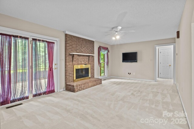 unfurnished living room featuring baseboards, visible vents, a ceiling fan, and light colored carpet