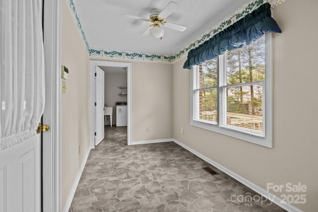 unfurnished bedroom with visible vents, baseboards, ceiling fan, a textured ceiling, and stone finish flooring