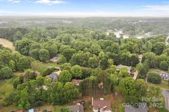 birds eye view of property with a forest view