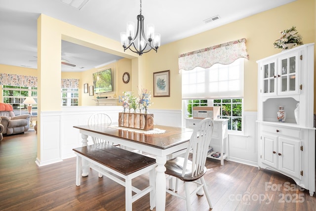 18027 Train Station Dr, Cornelius, NC 28031 - dining room with visible vents, dark wood finished floors, a wainscoted wall, ceiling fan with notable chandelier, and a decorative wall