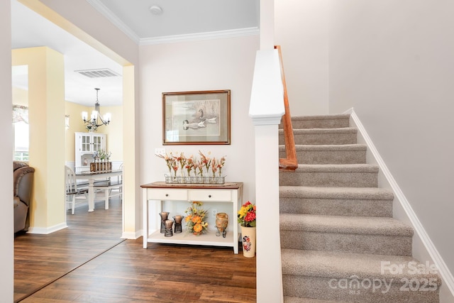 18027 Train Station Dr, Cornelius, NC 28031 - stairway with an inviting chandelier, baseboards, wood finished floors, visible vents, and ornamental molding