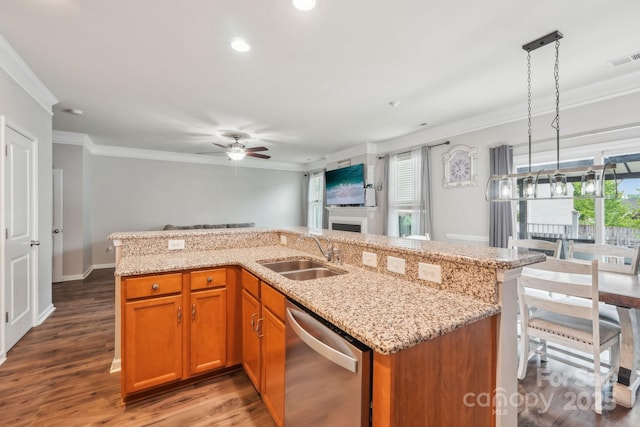 kitchen featuring stainless steel dishwasher, crown molding, a sink, and a healthy amount of sunlight
