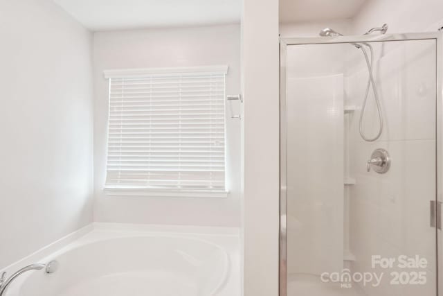 full bath featuring a shower stall and a bath