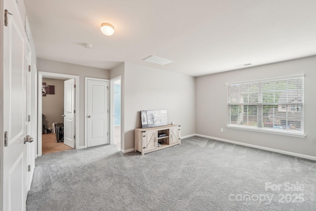 carpeted spare room with visible vents and baseboards