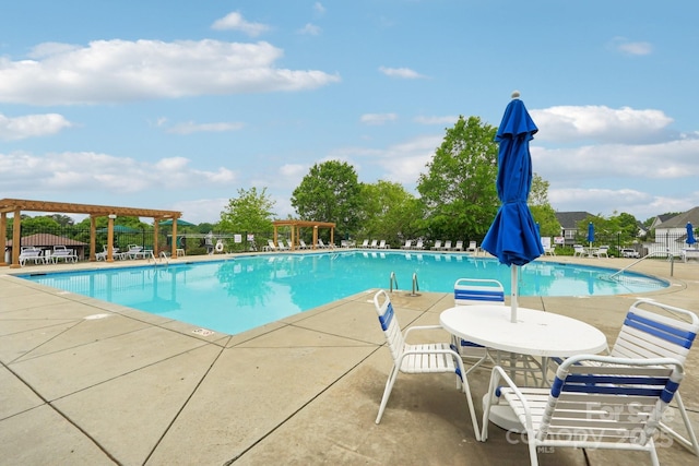 community pool featuring fence and a patio