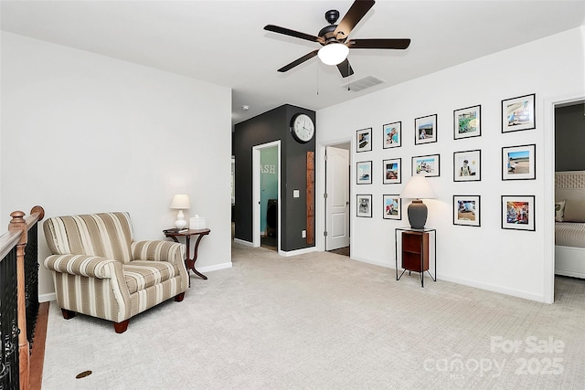sitting room with baseboards, ceiling fan, light colored carpet, and visible vents