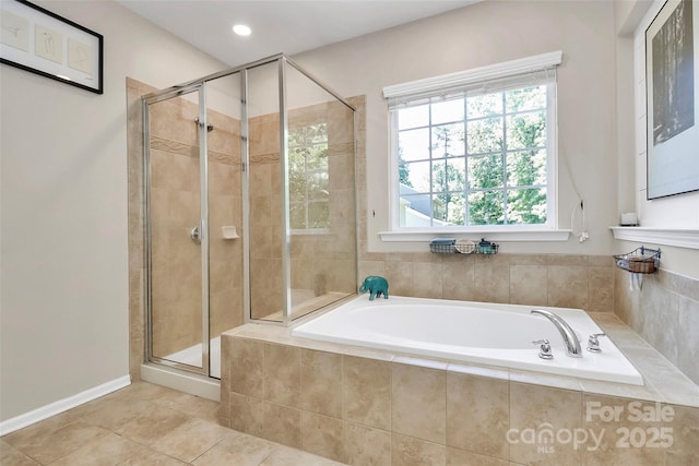 bathroom featuring recessed lighting, tile patterned flooring, a bath, and a stall shower