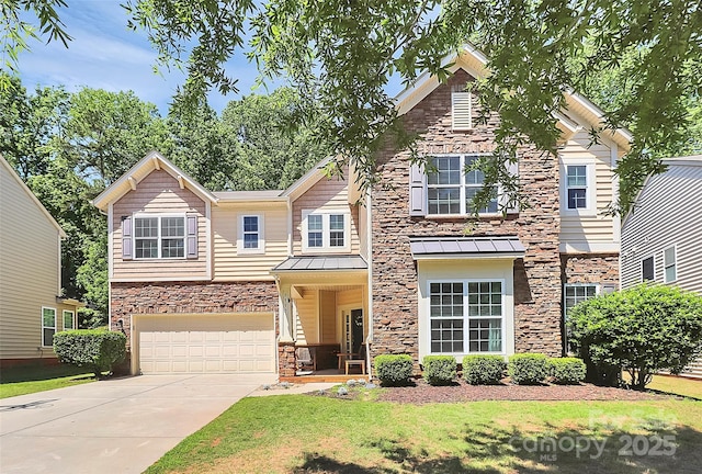 craftsman-style home featuring a standing seam roof, driveway, a front yard, a garage, and stone siding