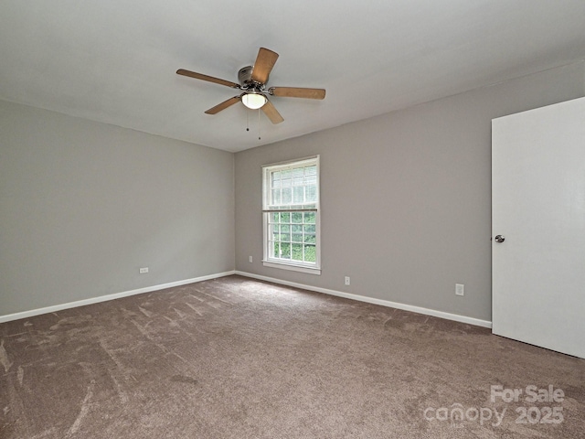 spare room featuring baseboards, carpet flooring, and ceiling fan