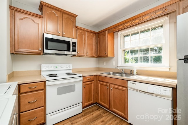 4609 Coronado Dr Unit N, Charlotte, NC 28212 - kitchen with stainless steel appliances, a sink, light wood-style flooring, light countertops, and brown cabinets