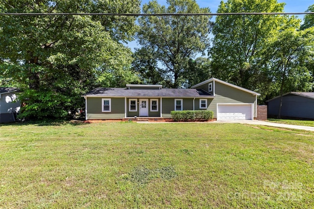 ranch-style house with driveway, a front yard, and a garage