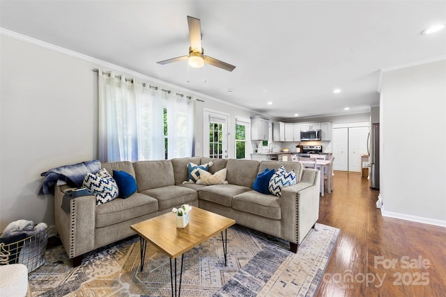 living area featuring ornamental molding, a ceiling fan, recessed lighting, and wood finished floors