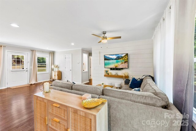 living area featuring a ceiling fan, baseboards, recessed lighting, and dark wood-type flooring