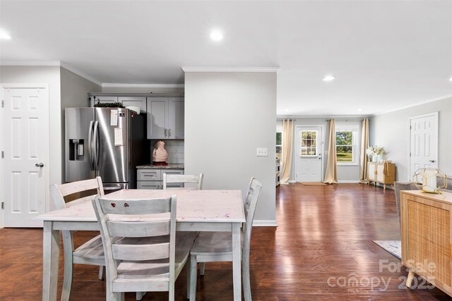 dining space featuring recessed lighting, ornamental molding, baseboards, and dark wood-type flooring