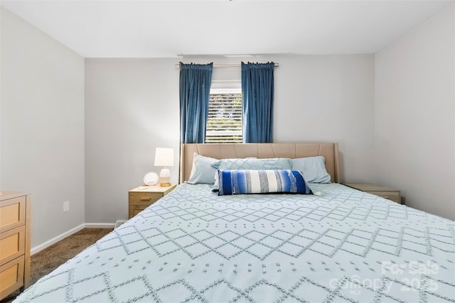 bedroom featuring baseboards and carpet
