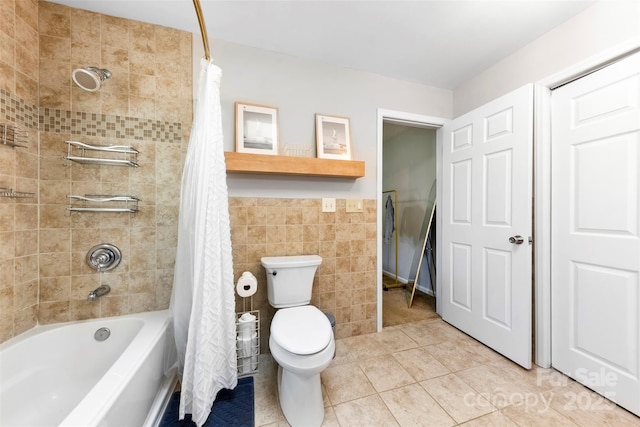 full bath featuring toilet, tile walls, tile patterned flooring, and shower / tub combo
