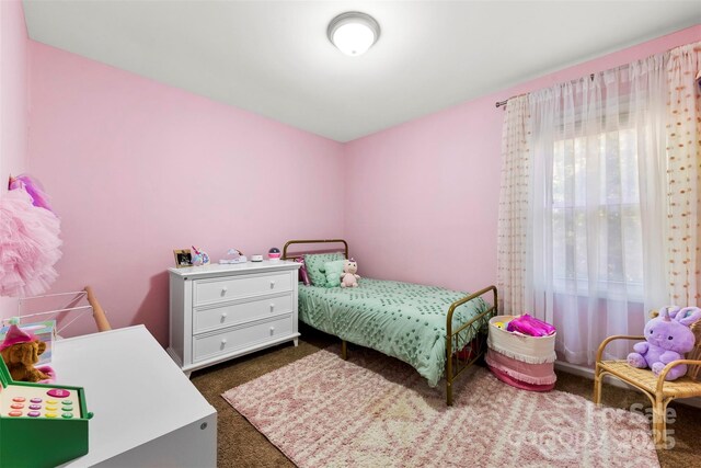 bedroom featuring dark carpet