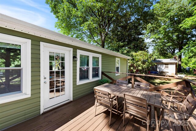 wooden deck featuring outdoor dining space
