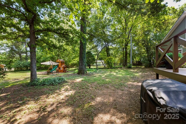 view of yard featuring a playground and fence