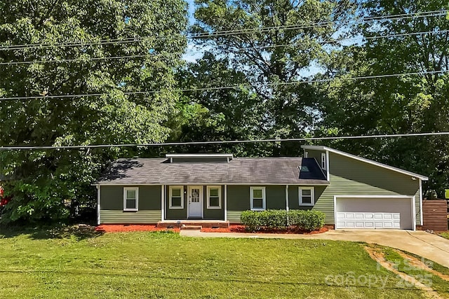 view of front of house featuring a garage, a front lawn, driveway, and covered porch