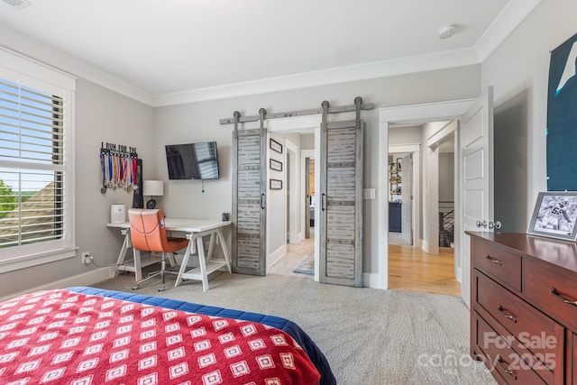 bedroom with baseboards, a barn door, carpet floors, and crown molding