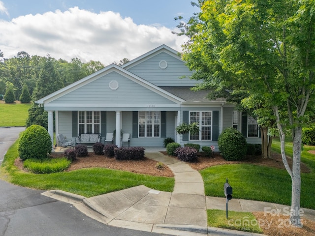 13360 Old Compton Ct, Pineville, NC 28134 - view of front facade featuring a front yard, roof with shingles, and a porch