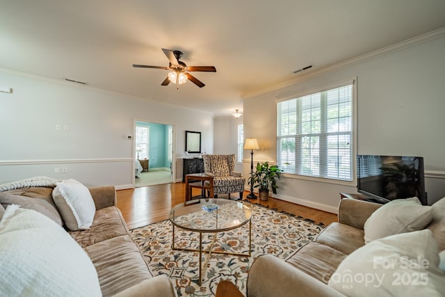 13360 Old Compton Ct, Pineville, NC 28134 - living area featuring visible vents, crown molding, a ceiling fan, and baseboards