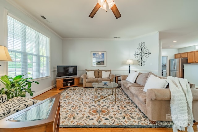 13360 Old Compton Ct, Pineville, NC 28134 - living room featuring crown molding, light wood finished floors, a ceiling fan, and visible vents