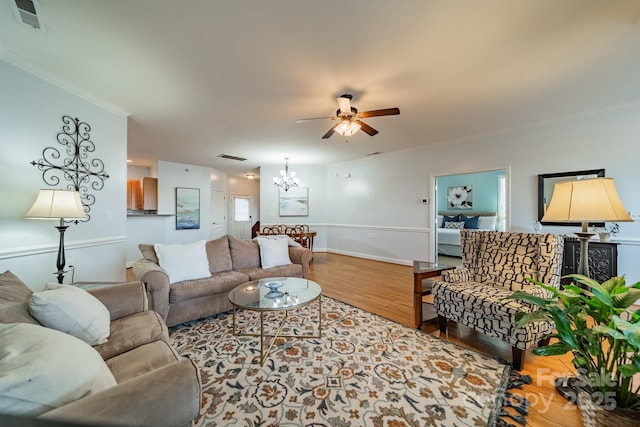 13360 Old Compton Ct, Pineville, NC 28134 - living room featuring wood finished floors, visible vents, ornamental molding, and ceiling fan with notable chandelier