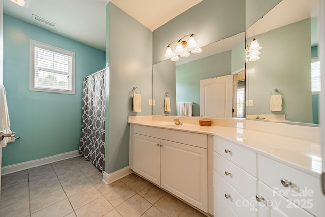 13360 Old Compton Ct, Pineville, NC 28134 - bathroom with visible vents, a wealth of natural light, tile patterned flooring, and vanity