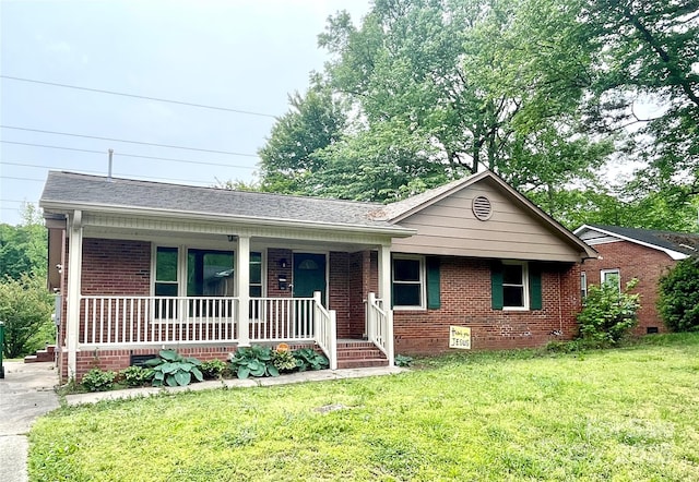 ranch-style home with covered porch, brick siding, a front lawn, and crawl space
