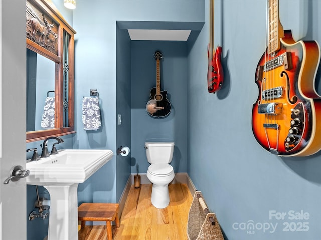 29 Ravenna St, Asheville, NC 28803 - bathroom featuring toilet, wood finished floors, and baseboards