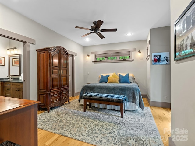 29 Ravenna St, Asheville, NC 28803 - bedroom with light wood finished floors, baseboards, a ceiling fan, and connected bathroom