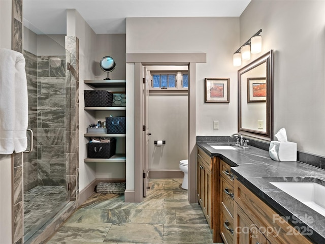 29 Ravenna St, Asheville, NC 28803 - full bathroom featuring a stall shower, toilet, double vanity, and baseboards