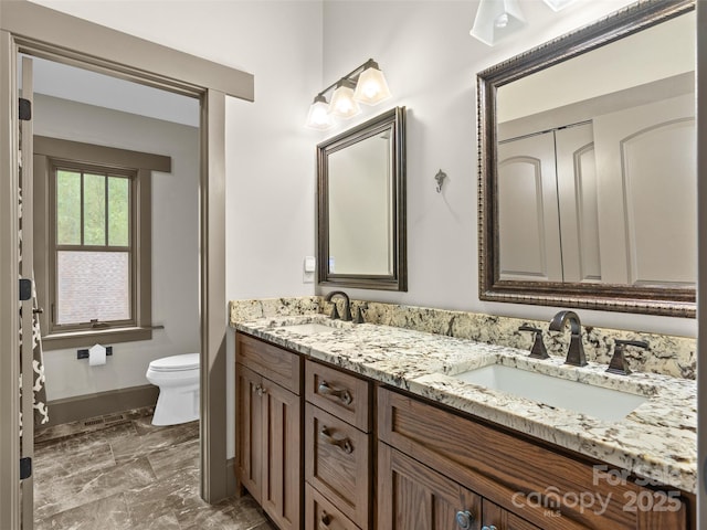 29 Ravenna St, Asheville, NC 28803 - full bathroom featuring marble finish flooring, toilet, baseboards, and double vanity