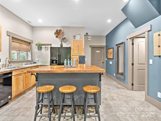 29 Ravenna St, Asheville, NC 28803 - kitchen featuring black appliances, a sink, a kitchen breakfast bar, light brown cabinetry, and a center island
