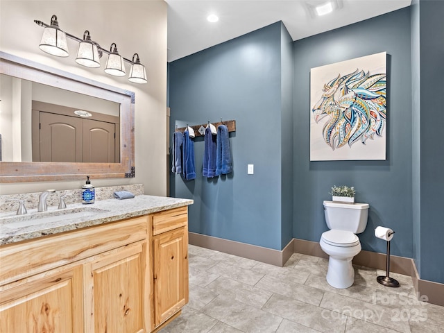 29 Ravenna St, Asheville, NC 28803 - bathroom featuring toilet, baseboards, and vanity